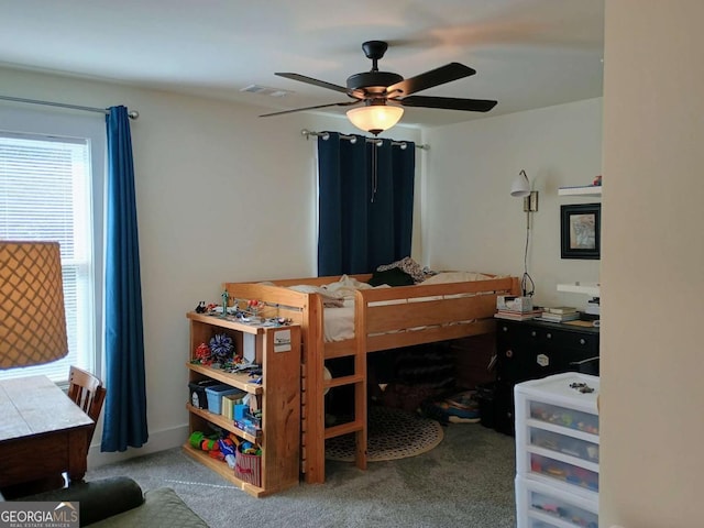 bedroom with carpet flooring, a ceiling fan, and visible vents