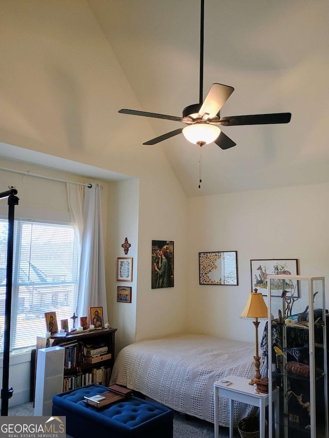 bedroom with ceiling fan and high vaulted ceiling