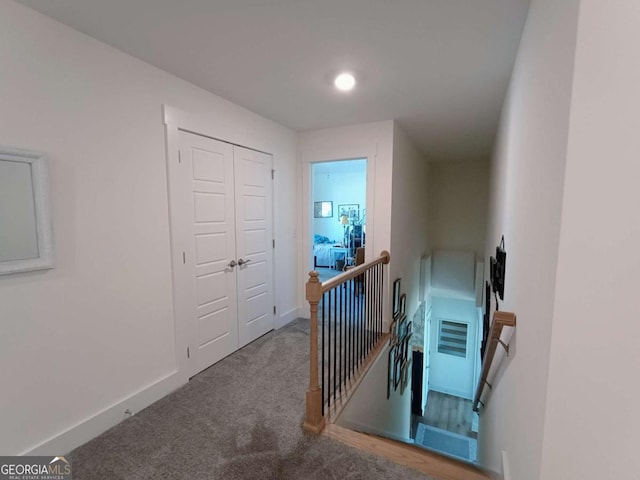 stairway with baseboards and carpet flooring