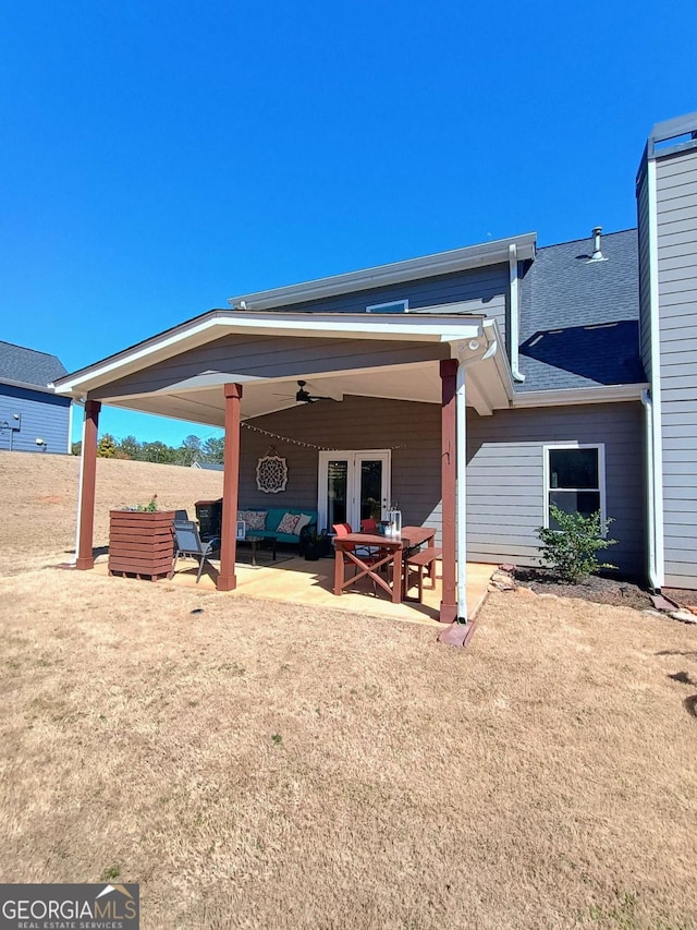 rear view of house featuring a patio area, french doors, a shingled roof, and a ceiling fan