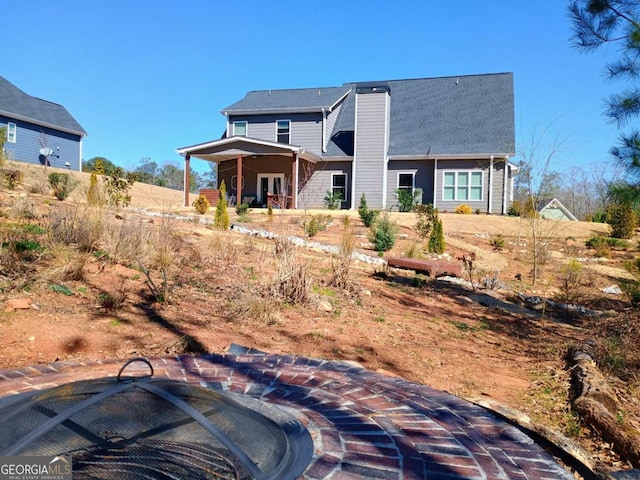 back of house with a chimney