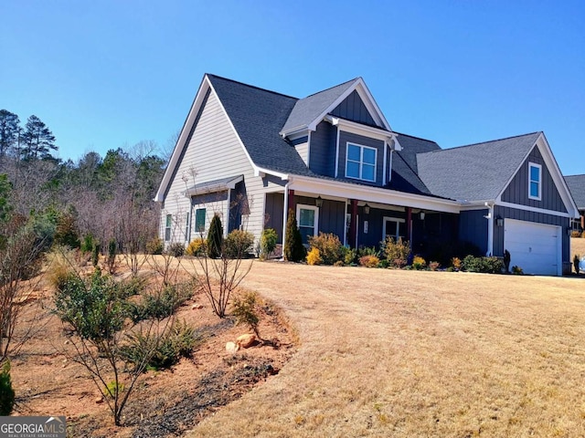 view of front of home with board and batten siding, a front yard, and a shingled roof