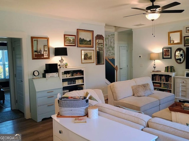 living area with visible vents, dark wood-style floors, and a ceiling fan