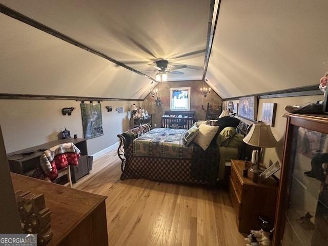 bedroom featuring lofted ceiling and light wood-style floors