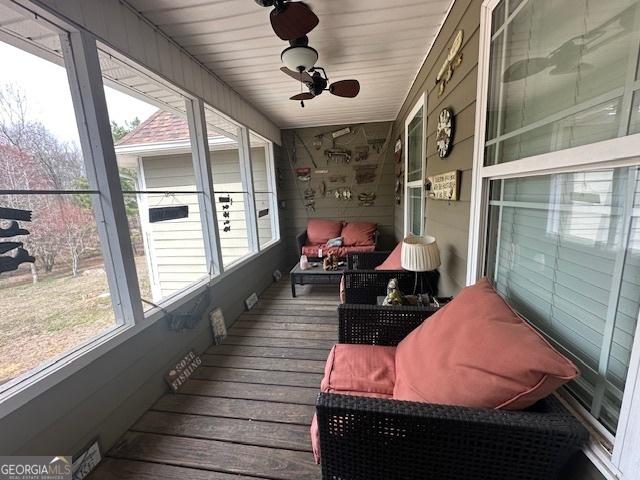 sunroom featuring a healthy amount of sunlight and a ceiling fan