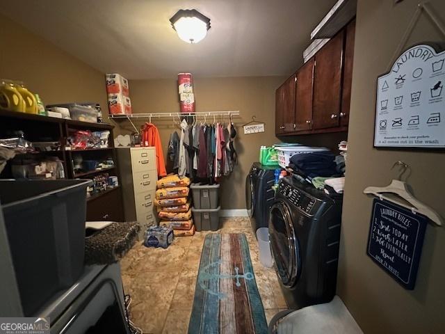 clothes washing area featuring tile patterned flooring, laundry area, and washer and clothes dryer