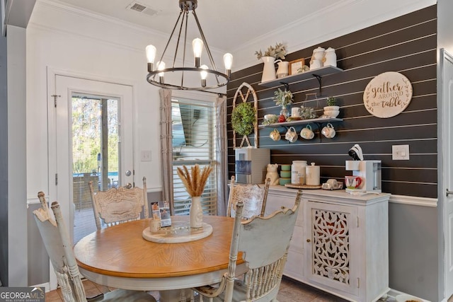 dining room with a notable chandelier, visible vents, and ornamental molding