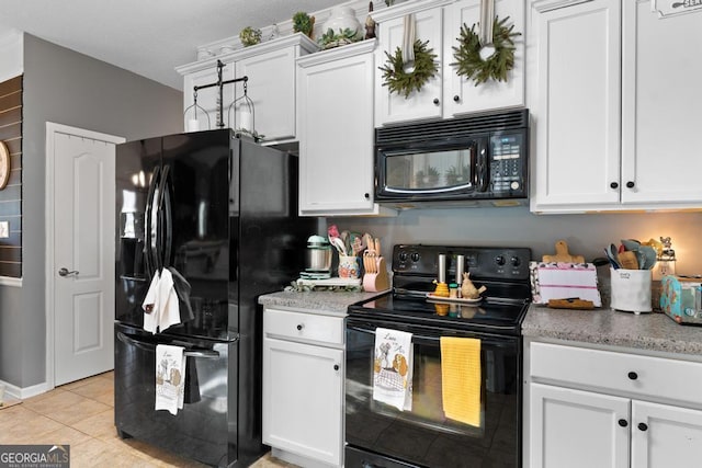 kitchen featuring light tile patterned flooring, white cabinetry, and black appliances