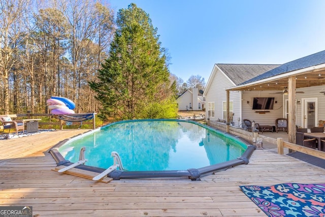 pool featuring a ceiling fan and a wooden deck