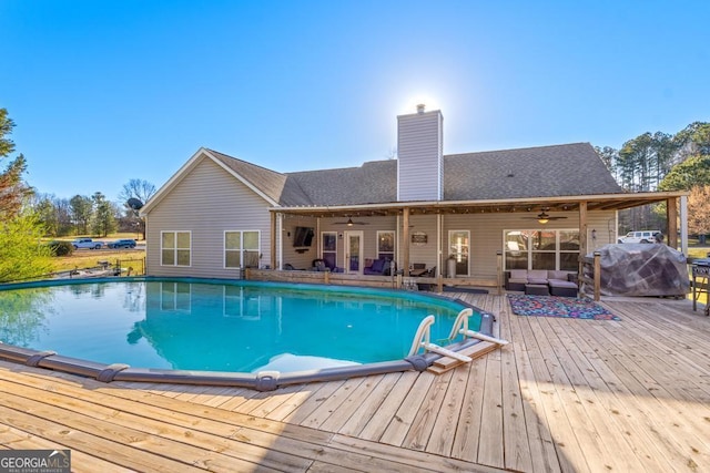 pool featuring a deck and ceiling fan