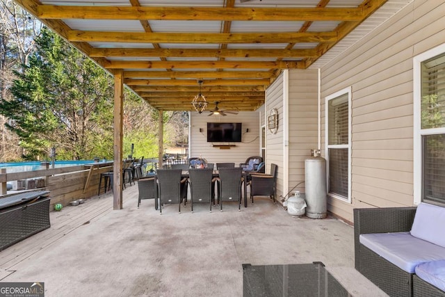 view of patio with outdoor dining space and a ceiling fan