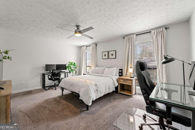 bedroom with carpet flooring, a textured ceiling, a ceiling fan, and baseboards