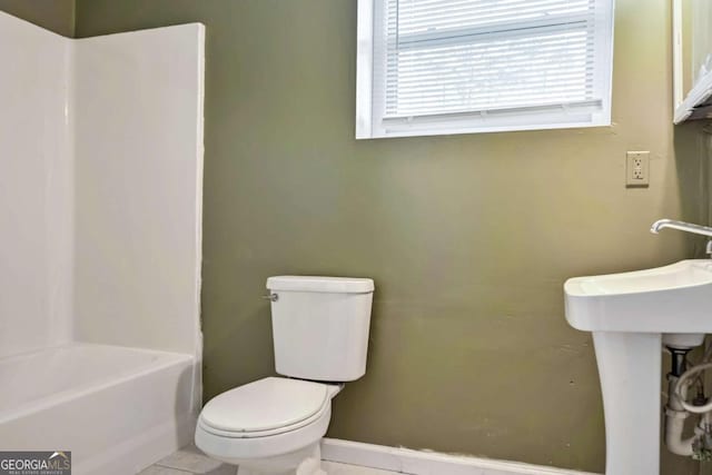 full bathroom with tile patterned flooring and toilet