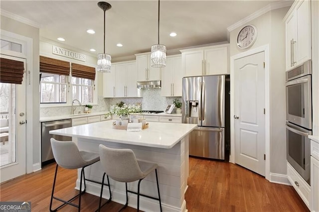 kitchen featuring stainless steel appliances, dark wood-style floors, range hood, and white cabinets