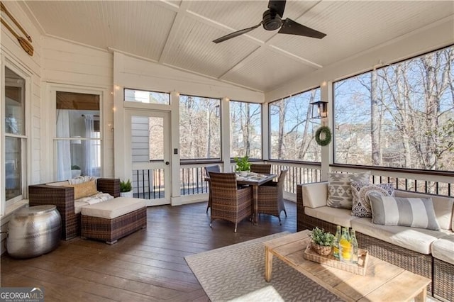 sunroom / solarium with lofted ceiling and a ceiling fan