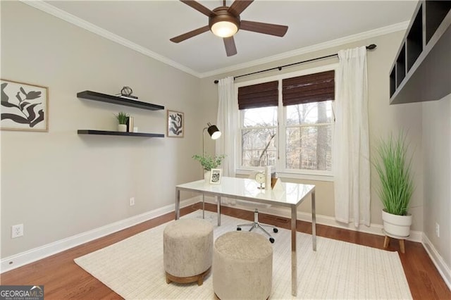 office area featuring crown molding, wood finished floors, baseboards, and ceiling fan