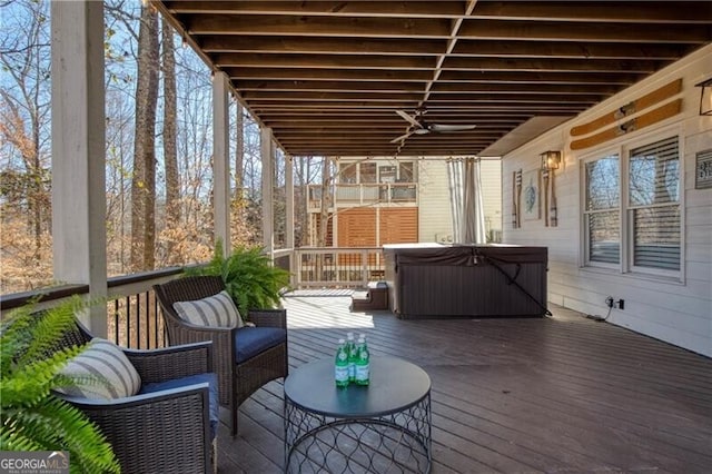 deck with a hot tub and ceiling fan