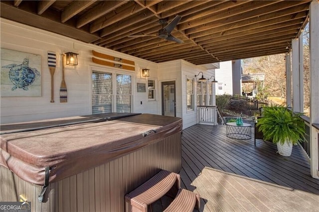 wooden deck with ceiling fan and a hot tub