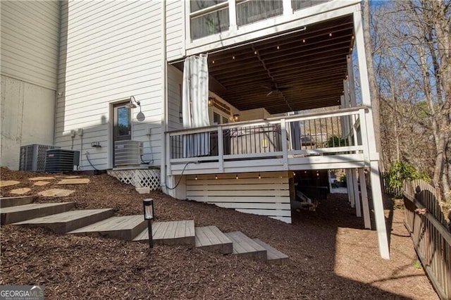 view of property exterior with central AC and a deck