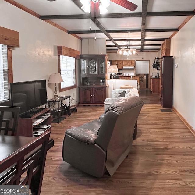 living area with beamed ceiling, dark wood-type flooring, coffered ceiling, baseboards, and ceiling fan