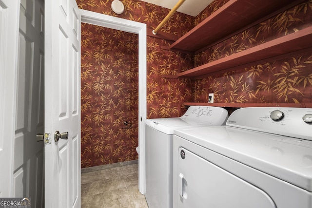 washroom with laundry area, wallpapered walls, baseboards, and separate washer and dryer