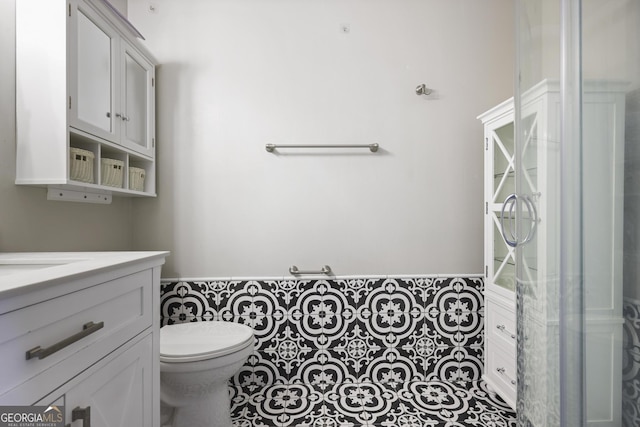 bathroom with vanity, toilet, and tile patterned flooring