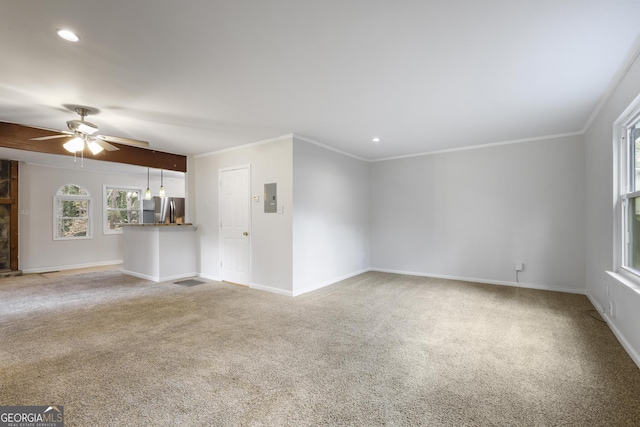 unfurnished living room with baseboards, carpet floors, a ceiling fan, and crown molding