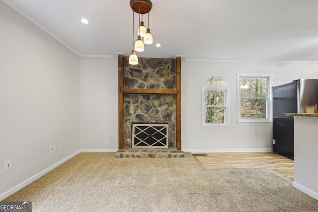 unfurnished living room with baseboards, carpet, and crown molding