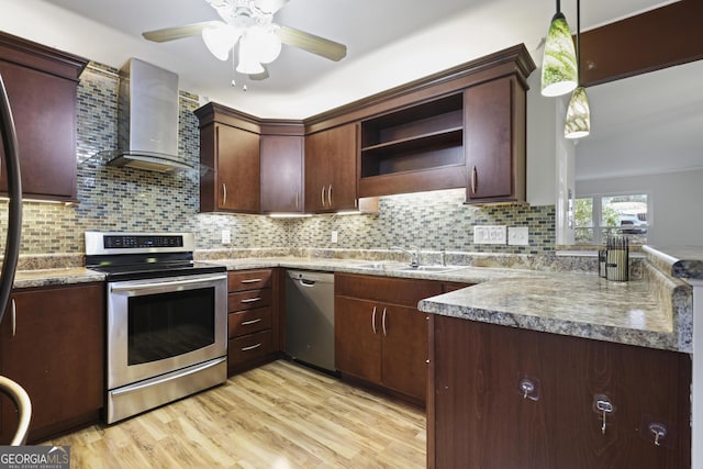 kitchen featuring open shelves, a sink, wall chimney range hood, stainless steel appliances, and light wood finished floors