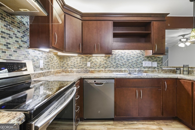 kitchen featuring a ceiling fan, a sink, open shelves, range hood, and appliances with stainless steel finishes