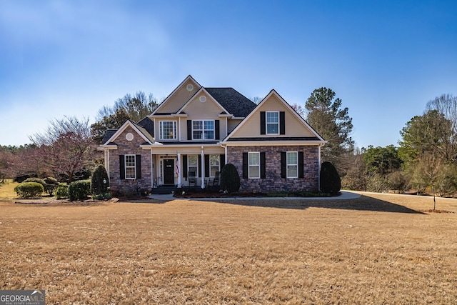 view of front facade with covered porch and a front yard