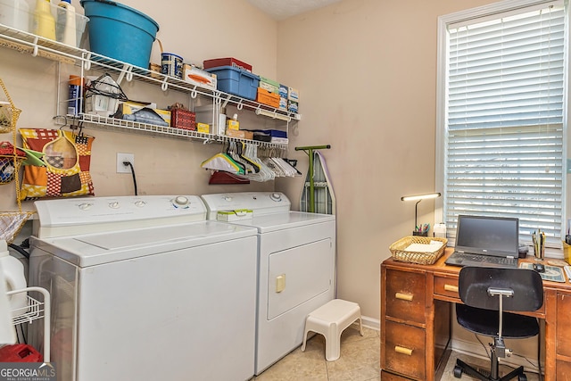 clothes washing area featuring laundry area, light tile patterned floors, and independent washer and dryer