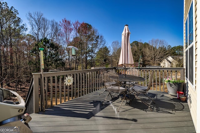 wooden terrace with outdoor dining area