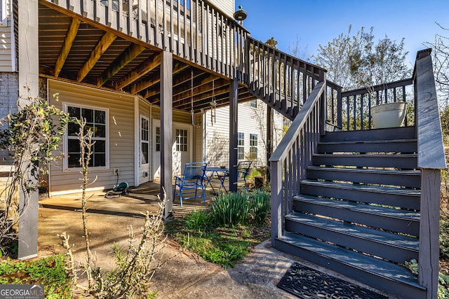 exterior space with stairway and a wooden deck