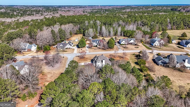 drone / aerial view with a wooded view