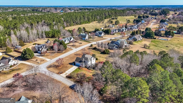 aerial view featuring a residential view and a wooded view