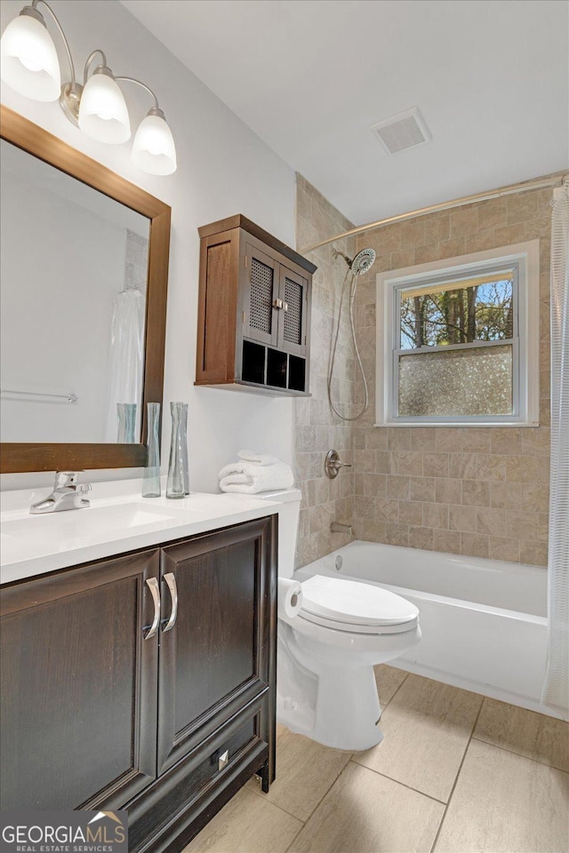 bathroom featuring visible vents, vanity, toilet, and shower / tub combo