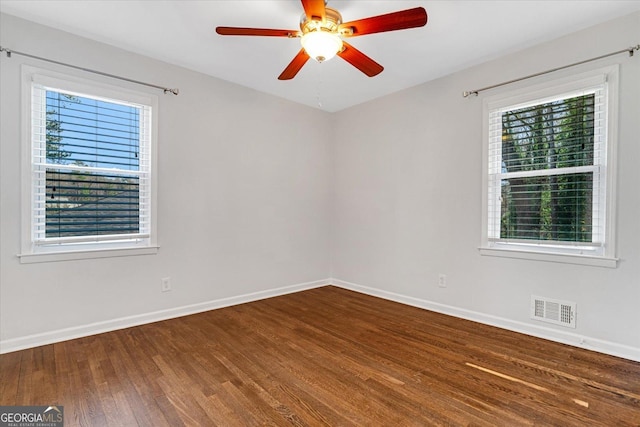 spare room with a healthy amount of sunlight, visible vents, and baseboards