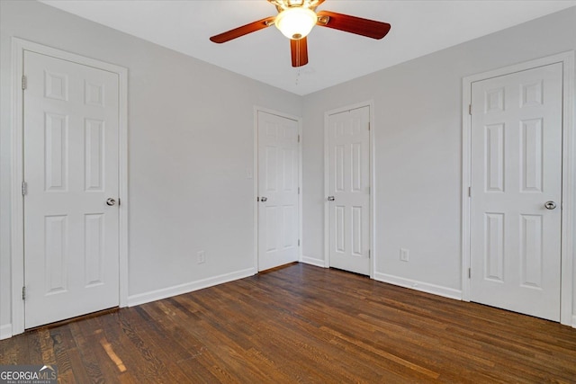 unfurnished bedroom featuring ceiling fan, baseboards, and dark wood-style floors