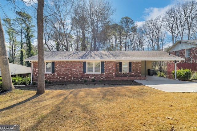 ranch-style home featuring a front lawn, concrete driveway, a carport, and brick siding