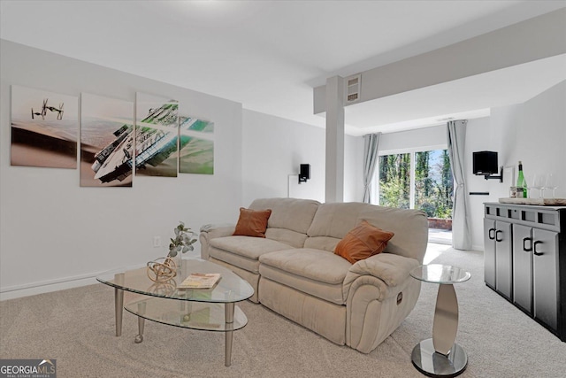 living area with visible vents, baseboards, and carpet floors