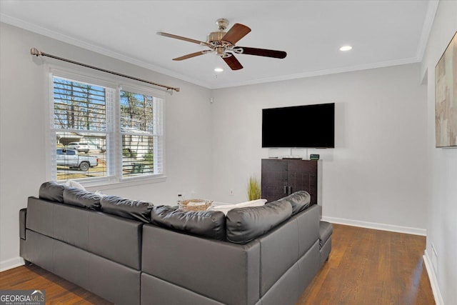 living area with ornamental molding, baseboards, and wood finished floors