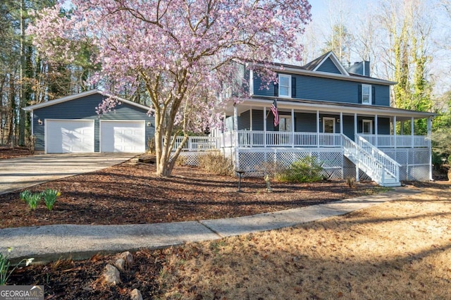 farmhouse featuring a detached garage and covered porch