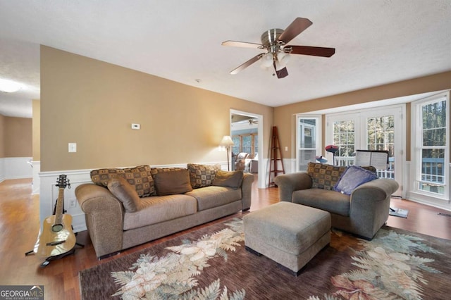 living area featuring a ceiling fan and wood finished floors