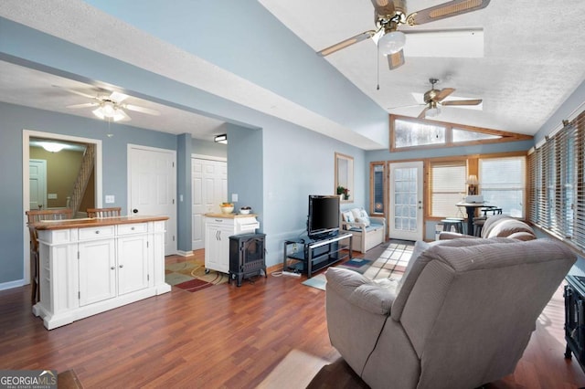 living room with dark wood-type flooring, baseboards, stairway, vaulted ceiling, and a textured ceiling