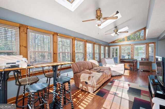 interior space with vaulted ceiling with skylight