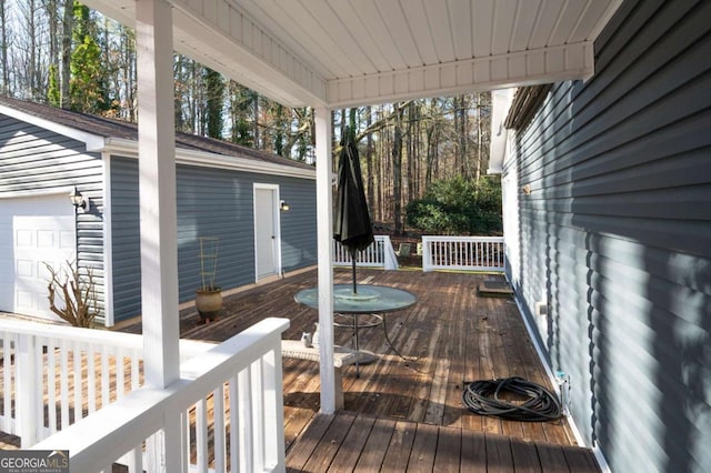 wooden terrace featuring an outdoor structure