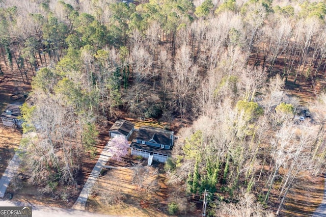 drone / aerial view featuring a wooded view