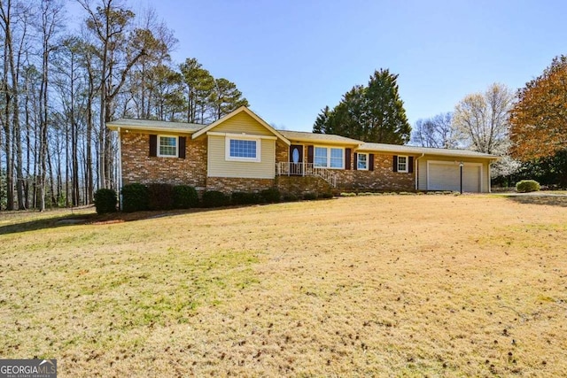 ranch-style house featuring a front lawn, brick siding, a garage, and driveway