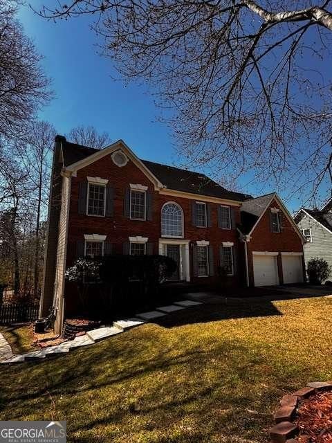 view of front of property with a front lawn and a garage